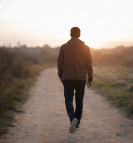 Individual walking forward at sunrise